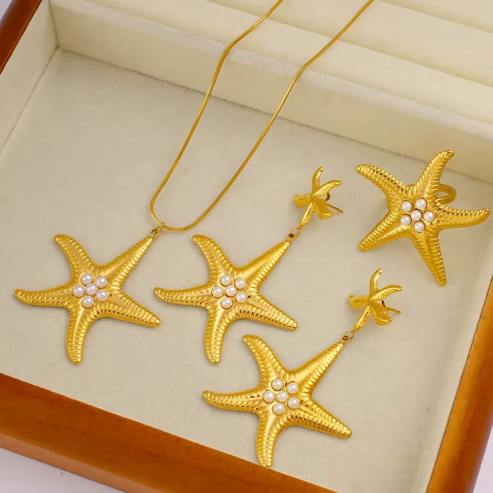 Gold starfish pendant necklace with pearl detailing