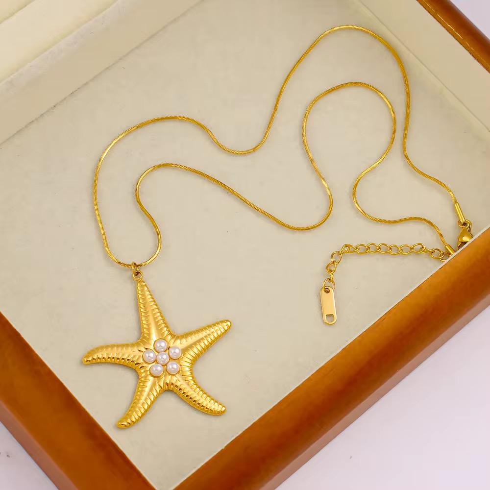Gold starfish pendant necklace with pearl detailing